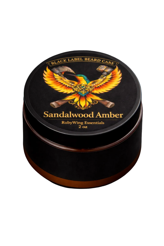 Black container of Sandalwood Amber with a colorful phoenix design on a dark background