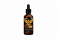 Load image into Gallery viewer, Bottle of Tobacco Vanilla beard oil with a colorful label featuring an eagle and flowers on a black background.
